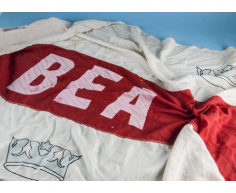 A vintage cotton BEA terminal flag, 272cm wide, together with a smaller terminal flag with red and white arrow shaped insigni