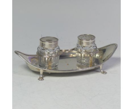 A George III silver Inkstand, by Henry Green, hallmarked London 1790, of navette shape with two silver mounted glass jars, on
