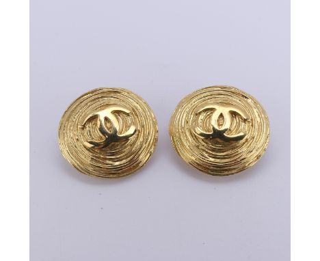 Chanel; A pair of gilt metal Earclips, of circular swirl form with CC logo to centre, marked on the reverse with collection n