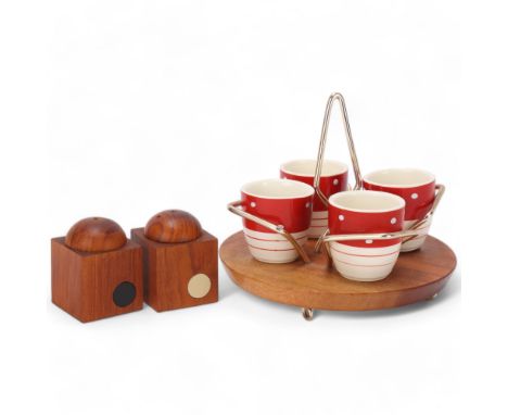 A mid 20th century teak salt and pepper set together with a Wyncraft teak based egg cup stand with label to baseAll in good c