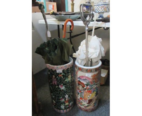 Two oriental design ceramic stick stands containing various vintage umbrellas and a metal shooting stick. (B.P. 21% + VAT) Mo