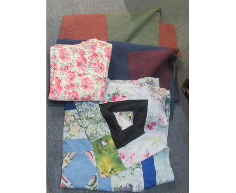 Four vintage quilts; two plain with different colours to the other side, a floral design and a patchwork with floral and blue