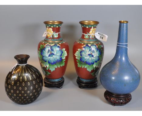 Collection of Chinese style cloisonne baluster vases including a pair with flowers and birds, all on hardwood stands. Togethe