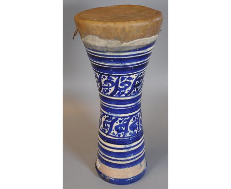 A blue and white ceramic North African or Middle Eastern single drum of waisted form. (B.P. 21% + VAT)