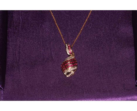 14k gold ruby and diamond pendant and chain.