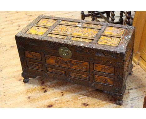 Heavily carved Camphor wood box with light stained panels, 89 by 43cm.