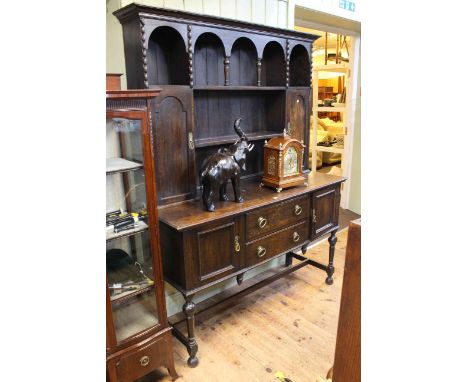 Oak dresser with shelf and cupboard rack above a base of two drawers flanked by cupboards on turned legs, 199cm by 152cm by 5