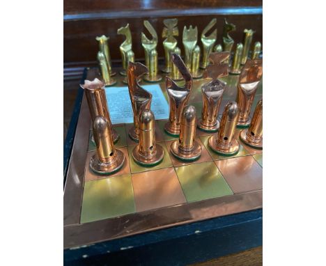 A Vintage Zimbabwe copper &amp; brass bullet design chess pieces and board 