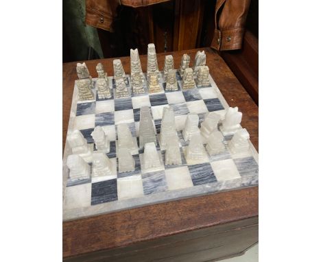 Heavy marble chess board together with hand carved hard stone chess pieces. 