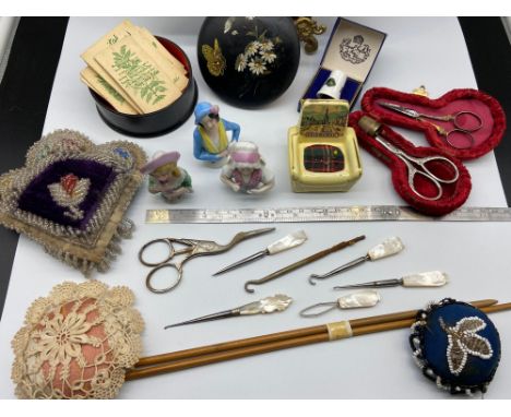 A Selection of collectable sewing items which includes three porcelain pin cushion ladies, Various bead work pin cushions, Va