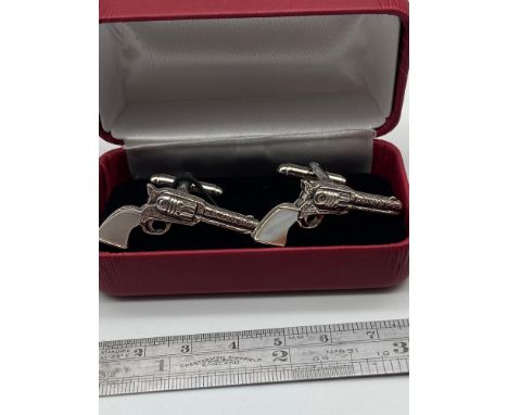 A Pair of Sterling silver pistol cufflinks with mother of pearl handles. 