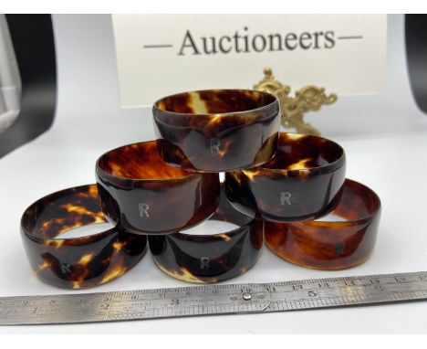 A set of 6 tortoise shell napkin rings Designed with a silver R initial inlay to each. 