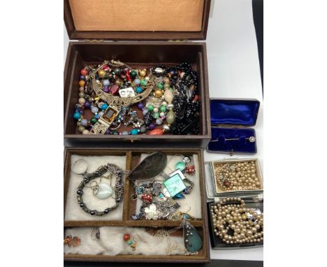 A Jewel box containing a quantity of vintage jewellery to include Pearl necklaces, Miracle celtic design necklace, Antique pi