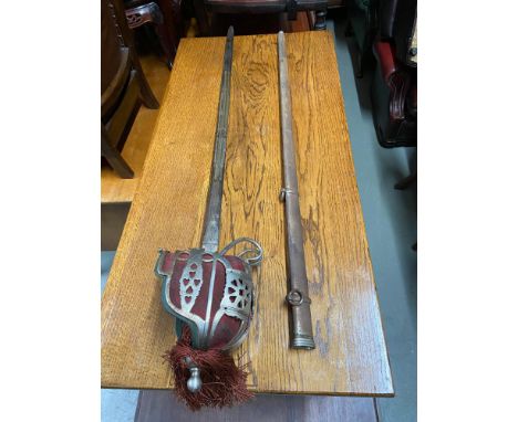 Antique officer cavalry sword and scabbard. Designed with ornate etched blade. 