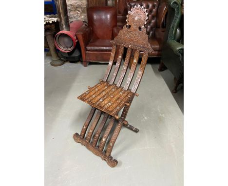 Antique Arabic folding campaign chair, designed with intricate carving and mother of pearl inlays. 