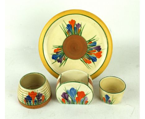 Four pieces of Clarice Cliff CrocusComprising teapot stand, diameter 16cm, bonjour shaped bowl, height 6.5cm, honey pot (lack