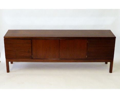 An excellent quality Danish rosewood sideboardHaving two end grid style doors, flanking two panelled cupboard doors, each enc