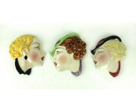 Three Cope & Co Art Deco ceramic wall masksEach depicting Art Deco female heads, impressed factory marks verso, length 19cm  