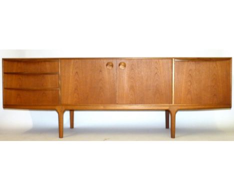 A mid Century teak sideboard, possibly G-PlanHaving three drawers, two panelled cupboard doors and a further pull down cupboa