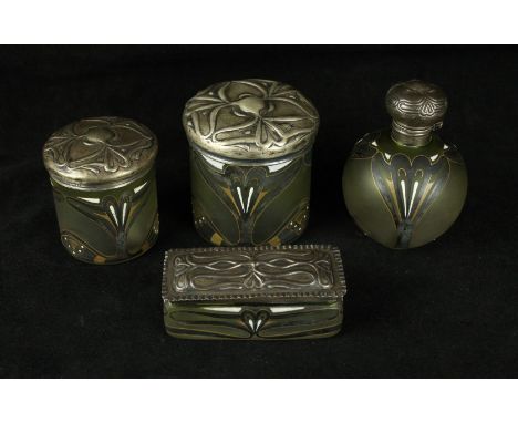 An Art Nouveau four piece glass dressing table setComprising lidded perfume bottle and three further lidded pots, each having