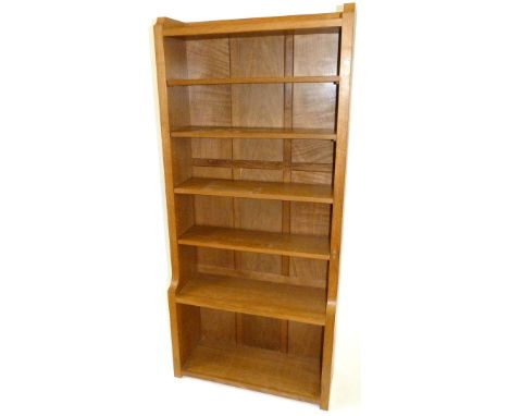 A Robert 'Mouseman' Thompson solid light oak open fronted book shelfHaving four assorted adjustable shelves, above compartmen