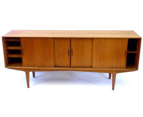 A mid Century teak sideboard
Having four panelled sliding doors enclosing shelves and three drawers, height 84cm, length 200c