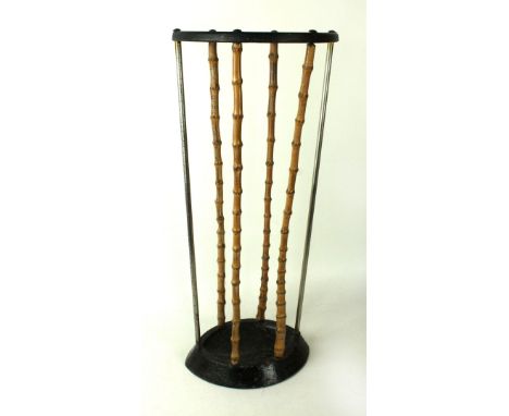 A mid Century cast iron and wooden stick standOf oval form, with bamboo type columns, height 50cm 