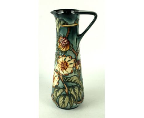 A modern Moorcroft pottery limited edition jug of slender formDecorated with stylised foliate on a light blue ground, by Kerr