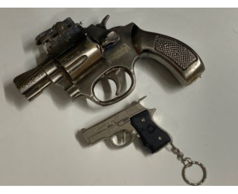 Novelty table lighter in the form of a snub-nosed revolver together with a pocket nine series 90 pistol key ring lighter