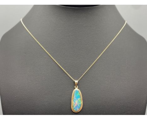 Ladies 14ct blue opal pendant complete with 9ct yellow gold chain, 2.7grm