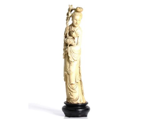 a fine antique, Chinese, antler or bone, young maiden. Republic period. She is holding lotus flowers and leaf in left hand, a