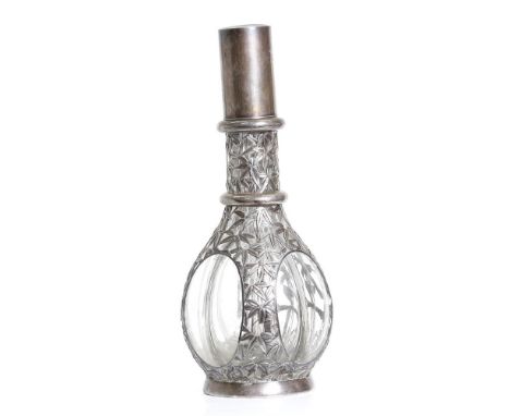 an antique, four chambered, crystal decanter. Silver coat, shaped as bamboo leaves, is covering the decanter. This unusual it