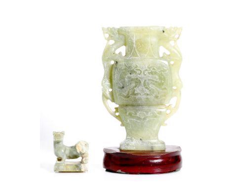 An old, Chinese, jade vase.  Lite green color. 2 dragon on the sides. Bellow the neck lotus petals. At the center 2 dragons. 