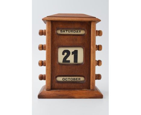 Vintage style perpetual calendar in wooden case with scroll like action, 17cm tall.  