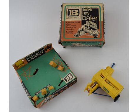 A boxed vintage diecast Britains Models,  Bamfords (JCB) Hay Baler. Complete with hay bails.  Diecast complete and in good co