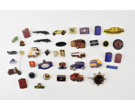 A collection of enamel badges relating to cars and motoring to include Michelin man, Lucas, Guy Motors, Land Rover, Jaguar, F