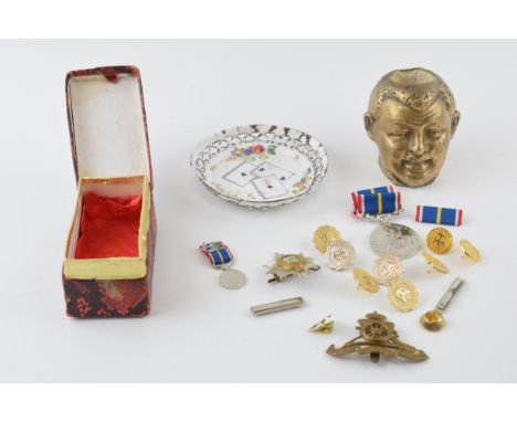 A collection of military medals and badges together with a match holder and strike and a enamelled copper tray with playing c