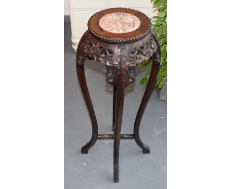 Oriental hardwood torchere stand, circular pink marble insert to top, stylised carved floral decoration with claw feet. Heigh