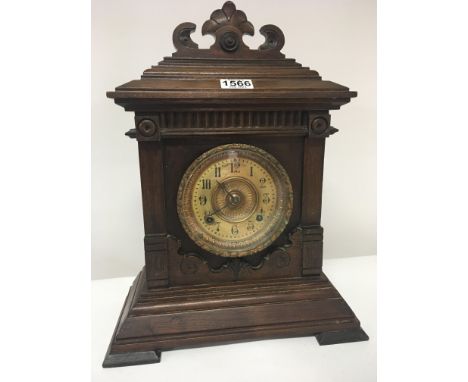 A Continental carved walnut mantel clock seen working.Hight 45cm.