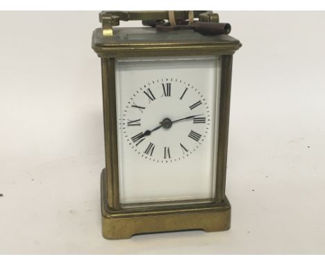 A brass case carriage clock the enamel dial with Roman numerals.10 cm .