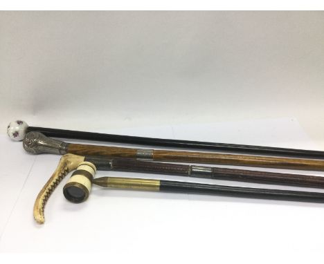 A silver handled sword stick, porcelain topped walking stick, riding crop and one other walking stick (4). Shipping category 