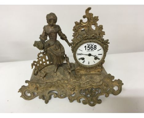 A late 19th century French gilded metal mantel clock with a figure of a girl with a basket. the movement striking on a bell.