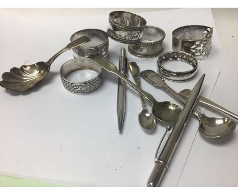 A silver caddy spoon together with other spoons napkin rings collection of silver plated and opera glasses.