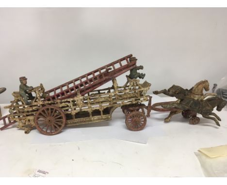 An interesting cast iron model of a horse drawer fire ladder with three horses and fireman. Length 70cm