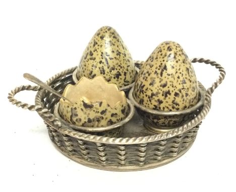 A rare silver plated unusual condiment set with ceramic simulated Lapwing eggs, including a miniature hallmarked silver spoon