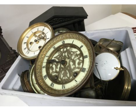 A Continental Gothic influence carved oak mantel clock a marble mantel clock and a box containing a quantity of clock movemen