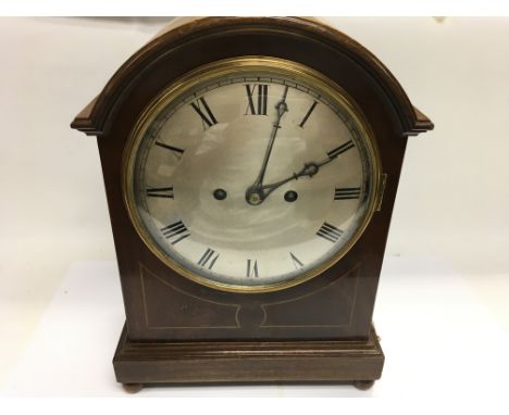 A mahogany mantle clock. Winds but not seen running. 11 inches wide by 15 inches tall. Postage D