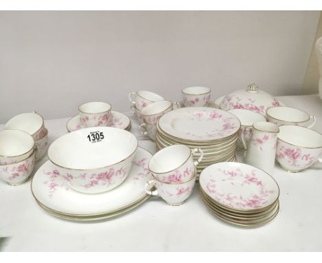 A Royal Worcester porcelain Edwardian muffin and tea part set delicately decorated with pink flowers and foliage.