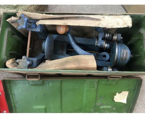 A hand canning machine in an ammunition box.