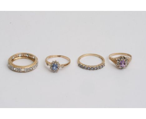 Four gold rings set with clear and coloured stones, approx 8.1g and sizes between K and P.